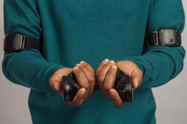 Hands holding controllers from virtual reality headset. VR technology gadget. - 写真・画像