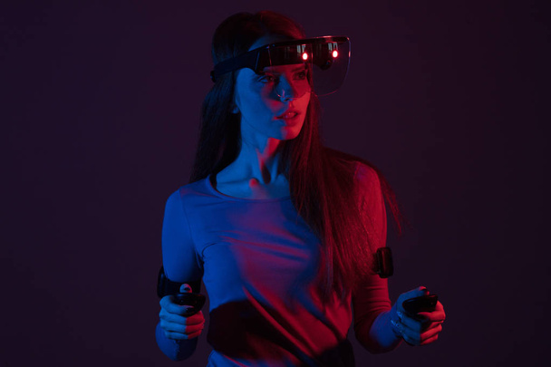 Woman watching with VR with red and blue light - Fotoğraf, Görsel