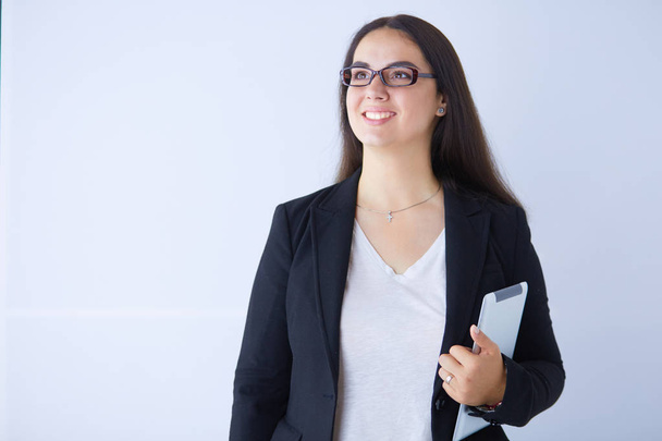 Portrait of smiling young business woman with digital tablet in her hands. - Φωτογραφία, εικόνα
