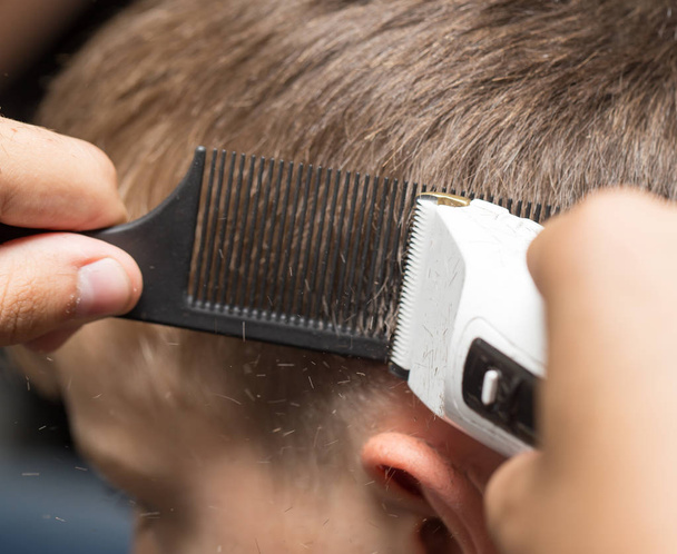 Man having a haircut with a hair clippers - Fotoğraf, Görsel