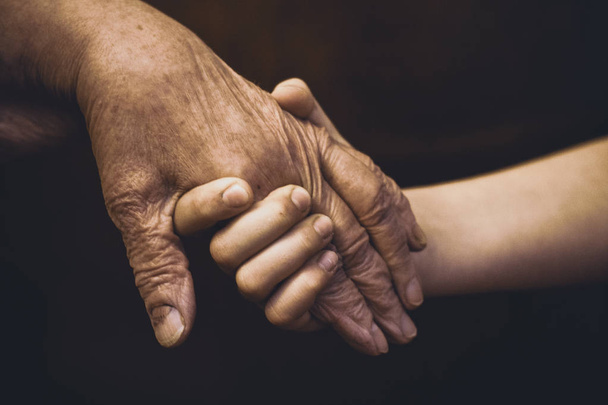 hands of different generations-old and children, hold each other. concept.  - Valokuva, kuva