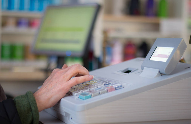 Cash register in a shop: Customer is paying purchase - Photo, Image