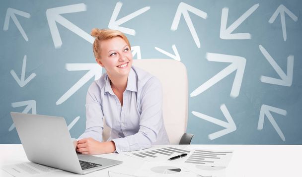 Business person sitting at desk with direction concept - Foto, Imagen