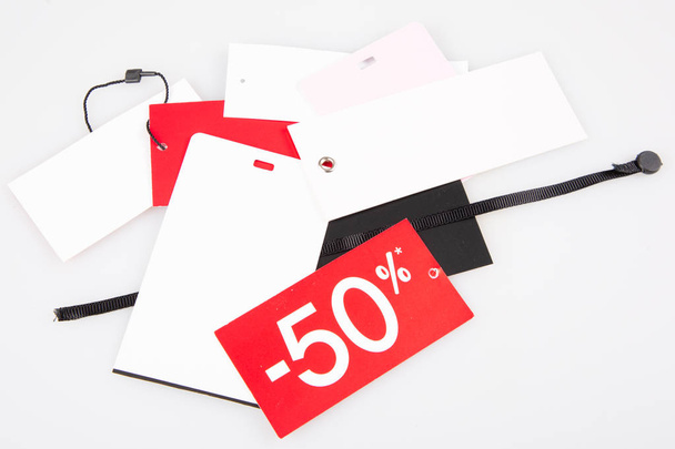 lot of tags labels sale 50% price for shop retal clothes - Фото, изображение