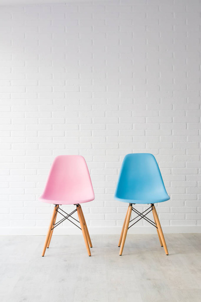 pair of chairs in pink and blue, equality concept - Фото, изображение