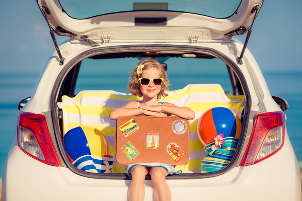 Happy child travel by car. Kid having fun on the beach. Summer vacation concept - Fotoğraf, Görsel