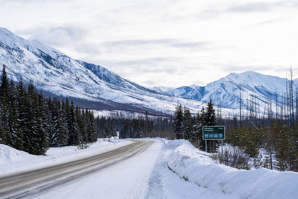 Sign along Highway 93 (Banff-Windermere Highway) en route to Kootenay National Park, shows drivers directions to Vermillion Crossing ahead. Taken in winter - Foto, imagen