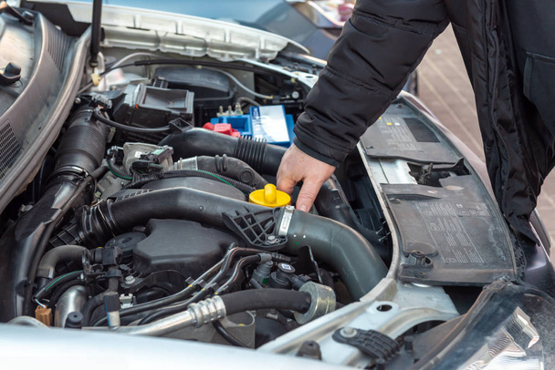Man checking oil level in car engine. - Photo, Image