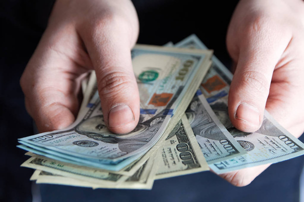 Man holdin money. Concept of savings, salary, payment and funds. Man counts cash bills - Fotó, kép