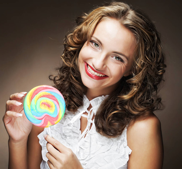 curly  girl with a lollipop in her hand  - Photo, image