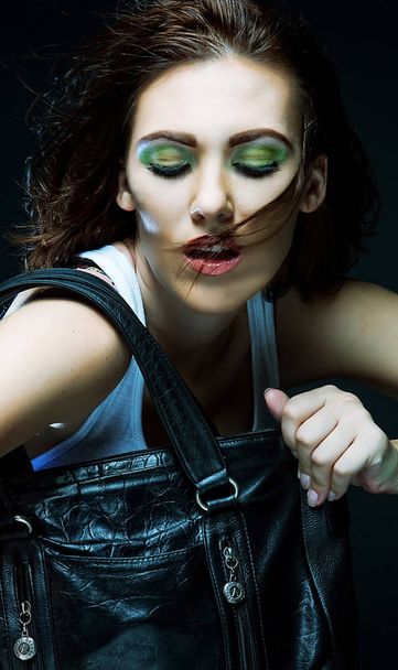 model with a bag posing on black background  - Foto, Imagem