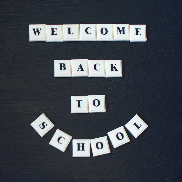 Welcome back to school lettering on blackboard. Back to school inscription on chalkboard. Message on chalkboard. Top View. Banner Concept. - Photo, Image