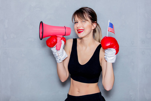 donna in guanti da boxe con altoparlante e bandiera USA
 - Foto, immagini