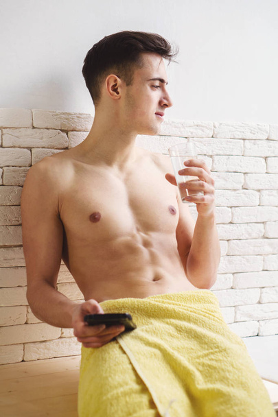 morning routine, awakening, fit man drinking water - Fotografie, Obrázek