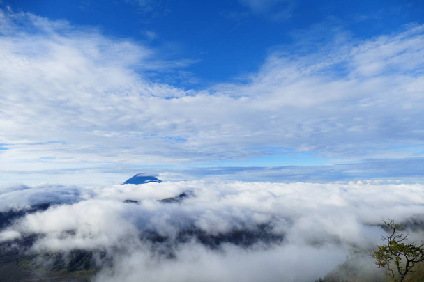The delightful volcanic complex Bromo Tengger Semeru National Park against the background of fascinating views of nature, sky, craters and clouds. - Foto, imagen