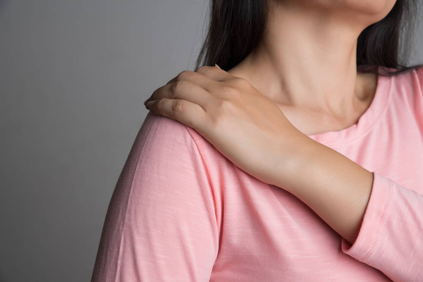 Closeup woman shoulder pain and injury. Health care and medical concept. - Fotó, kép