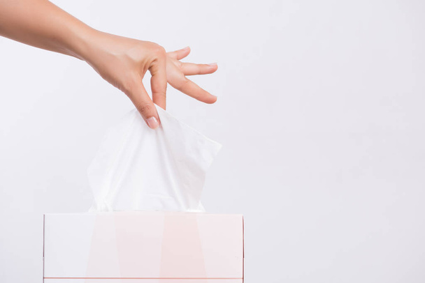 Healthcare concept. Woman hand picking white tissue paper from tissue box. - Photo, Image