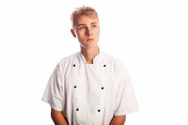 Mladý kuchař s toužebně volných vypadat izolované na bílém pozadí vzhlédl na pravém horním rohu rámu - Fotografie, Obrázek