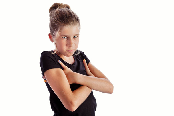 Young girl with black shirt isolated on white background with hands under arms in closed angry pose. Inspiration for meme or mother I don't like you pose - Photo, Image