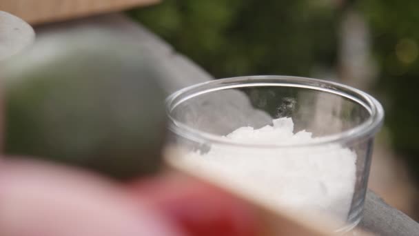 Close up shot on salt in a glass container. Blurred background. - Video, Çekim