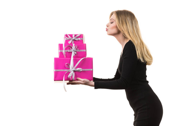 People celebrating xmas love and happiness concept. Sweet blonde girl holding presents stack of pink gift boxes, sending kiss, on white - Fotoğraf, Görsel