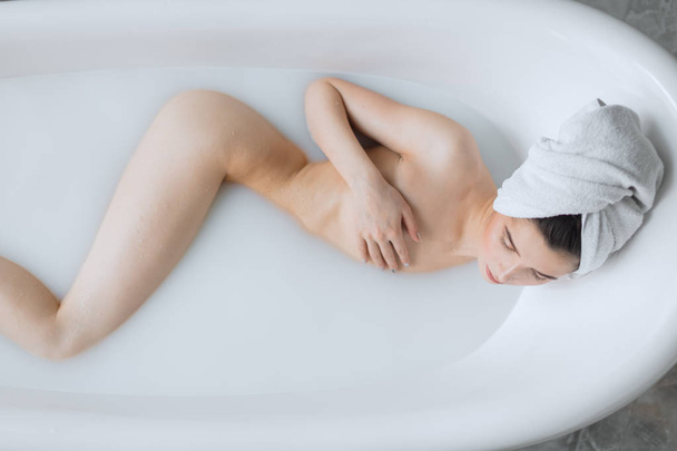 Beautiful young woman taking bath at home - Fotoğraf, Görsel