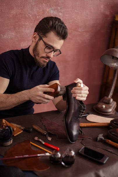 guy using the brush for footwear - Photo, image