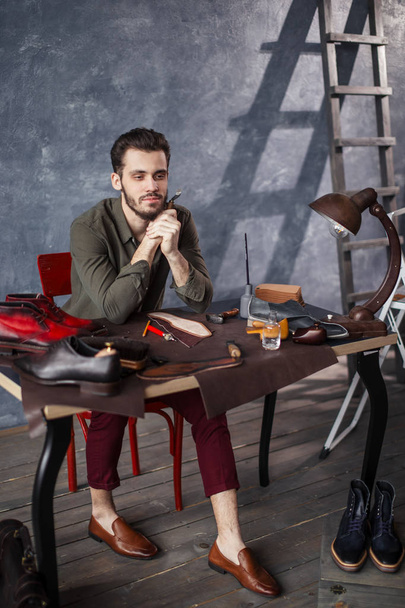romantic shoemaker having a rest during working day - Foto, afbeelding