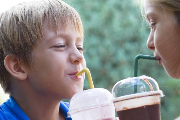 Funny little children drink milkshake - Foto, imagen