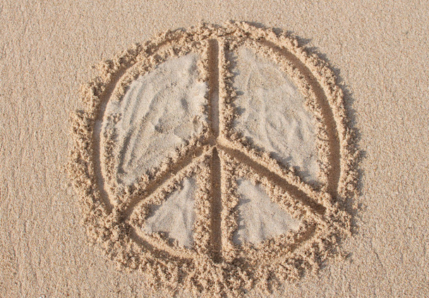Peace symbol drawn and filled with white sand at Melasti beach in Bali, Indonesia - Photo, Image