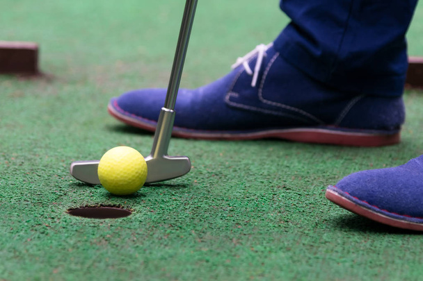 player's last shot before the hole in mini-golf, close-up - Foto, Bild