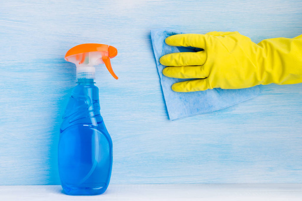 glass cleaner and rag in hand on a light background - Фото, изображение