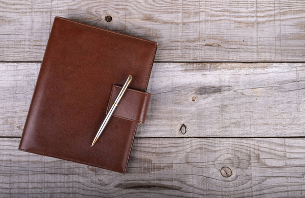 businessman's agenda and pen on wooden background - Photo, Image
