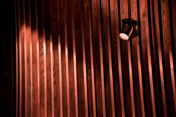 Abstraction image with a striped background of designer wooden rails and a lamp - Zdjęcie, obraz