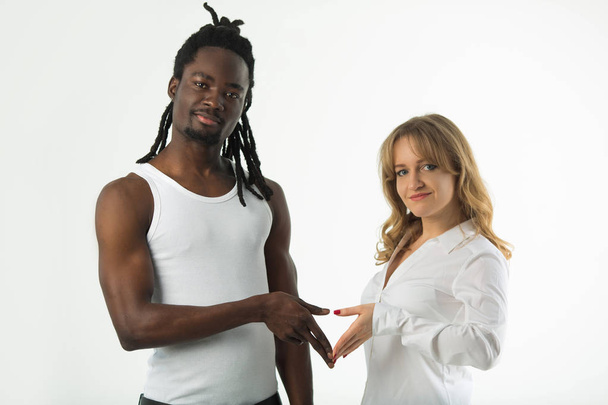 portrait of girl with boyfriend on white background with hand gesture - Fotografie, Obrázek