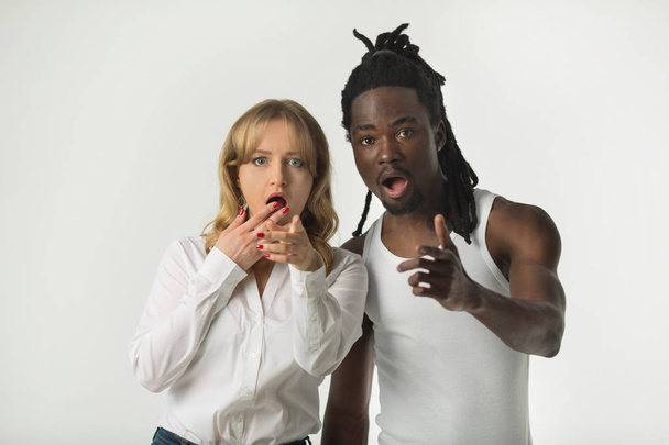 portrait of a girl with a guy on a white background with frightened faces - Foto, afbeelding