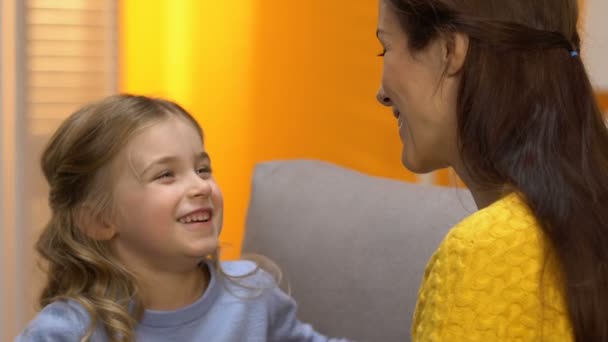 Sweet preschool laughing girl hugging happy mother, tender relations slow motion - Záběry, video
