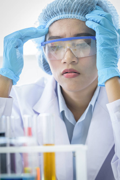 Asian young girl student scientist feeling sad researching  and learning in a laboratory. - Photo, Image