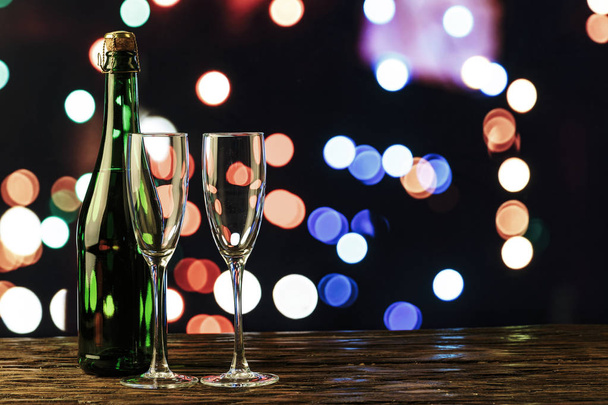 champagne in a glass and in a bottle on the background of New Year's boke - Foto, Imagen