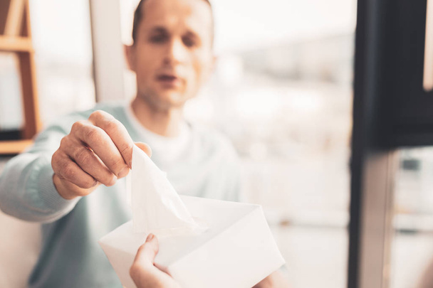 Man suffering from allergy taking napkin - Foto, immagini
