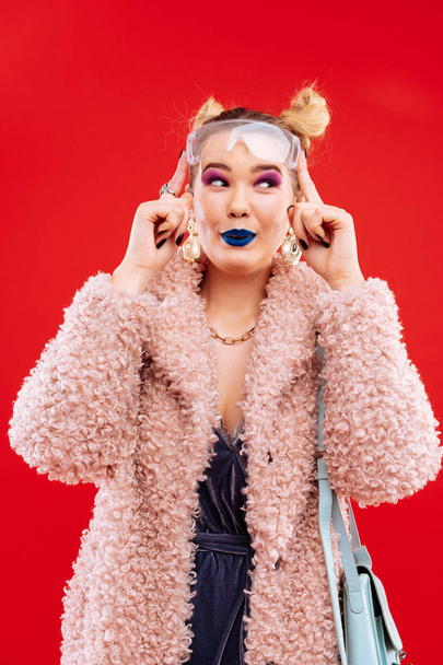Millennial woman wearing pink fluffy coat and accessories - Fotoğraf, Görsel