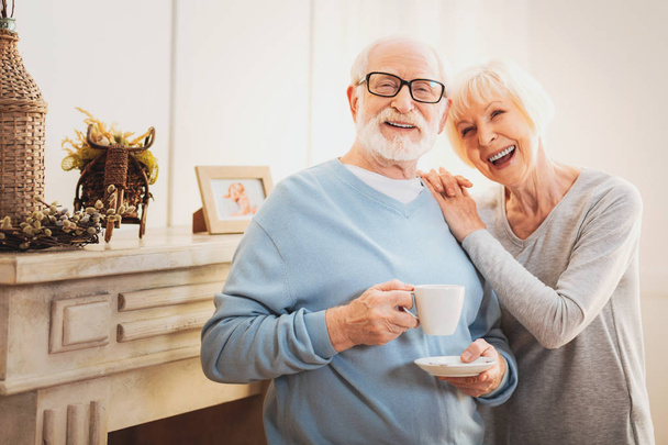 Laughing elderly wife feeling happy standing near her man - Photo, image