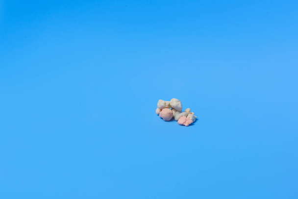 Colorful gum on a blue background. Gum. Culinary product. Chew gum. Used product. Chewing gum was chewed. Already been chewed. Inedible elastic base. - 写真・画像