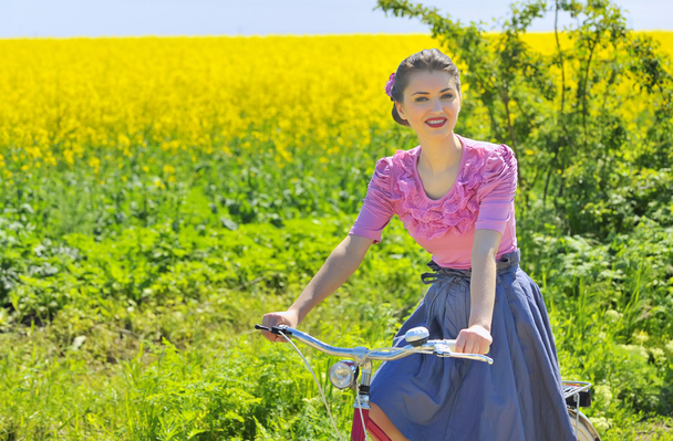 girl on bike in spring time - Photo, Image