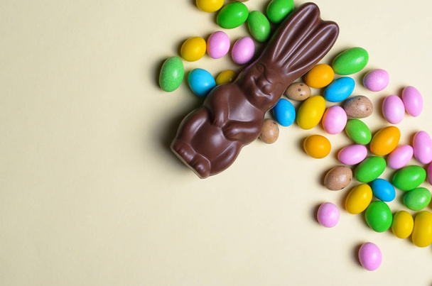 Easter Bunny and Chocolate Eggs on Bright Background, Sweet Easter Treats, Holiday Concept - Photo, Image