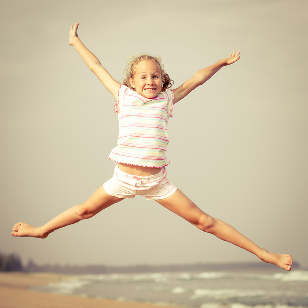 flying jump beach girl on blue sea shore in summer vacation - Zdjęcie, obraz