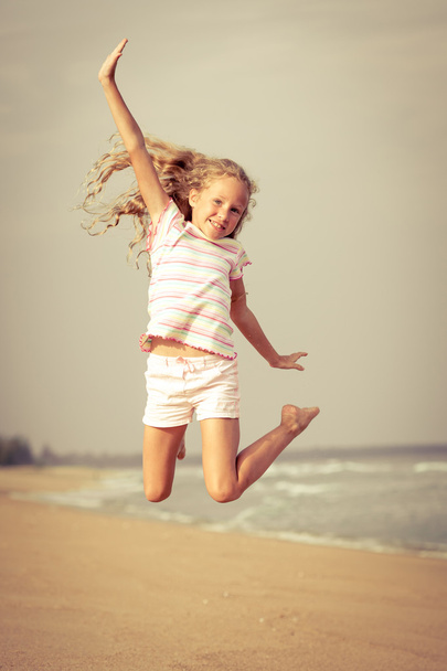 flying jump beach girl on blue sea shore in summer vacation - Foto, imagen