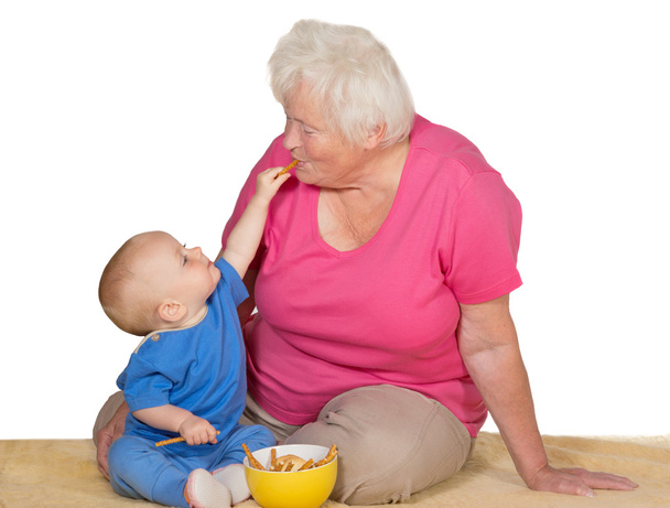 Tender moment between baby and grandmother - Photo, Image