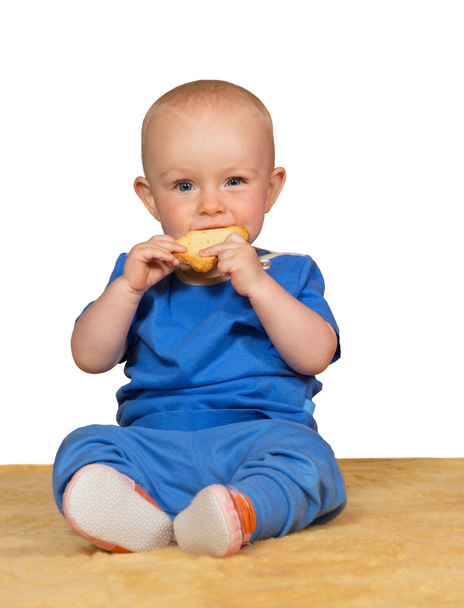 Adorable baby eating a bun - Foto, afbeelding
