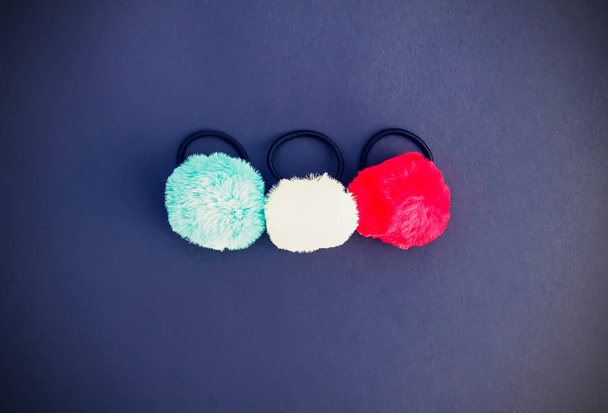 Colorful fluffy pompons on bright background. Fashion decoration festive template. - Photo, Image